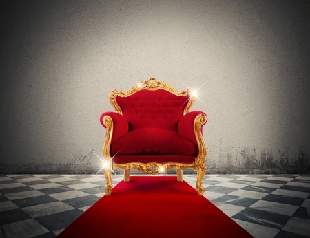 45342172 - sparkling golden armchair in a red carpet